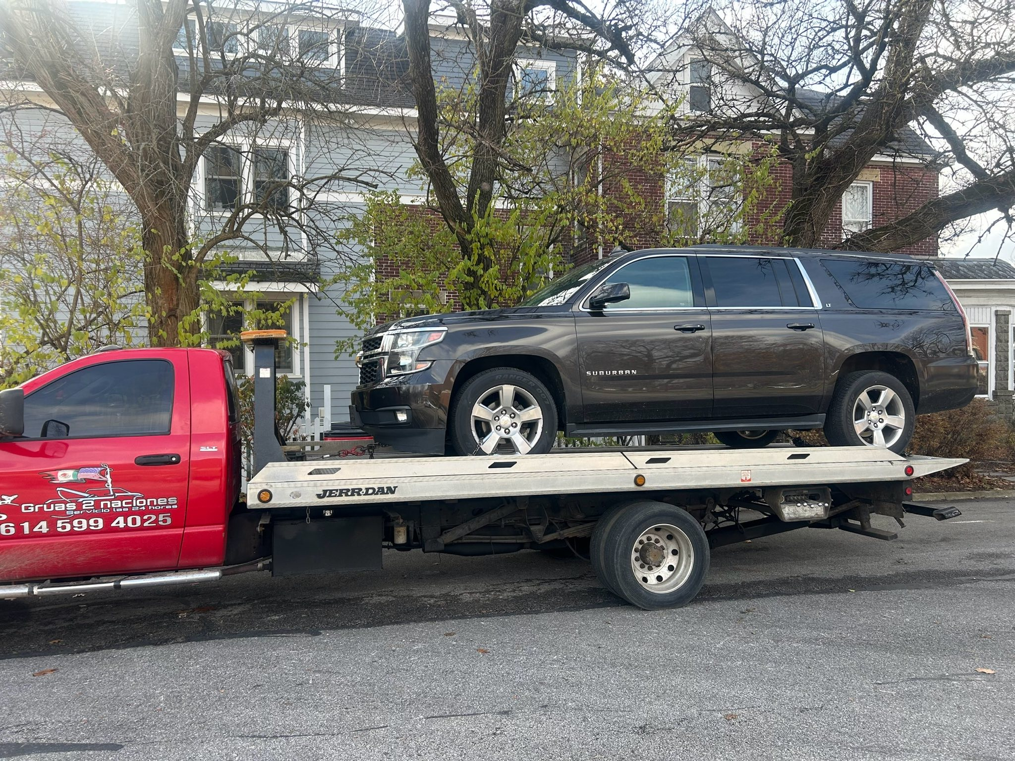 Flatbed towing a Chevrolet Suburban in Columbus